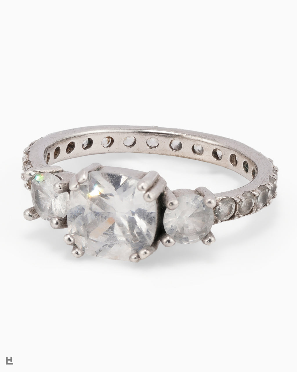 Bague trois pierres avec centre taille coussin et anneau entièrement serti